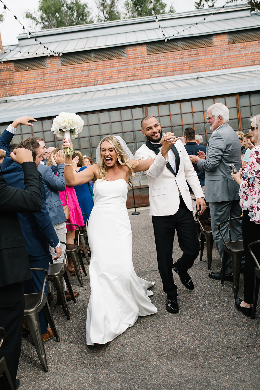 Candid wedding portrait of a couple in downtown Denver, taken by a documentary wedding photographer.
