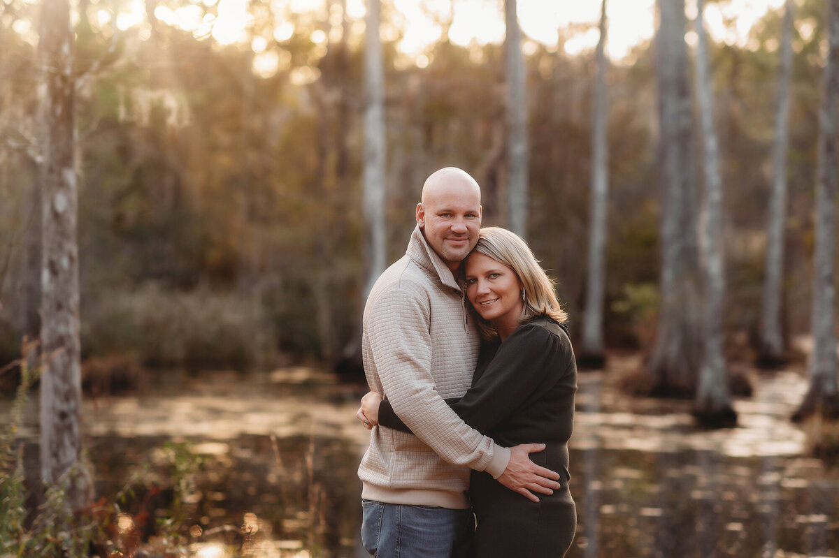 Couple embraces each other during their Family Photoshoot at Cypress Gardens near Charleston, South Carolina.