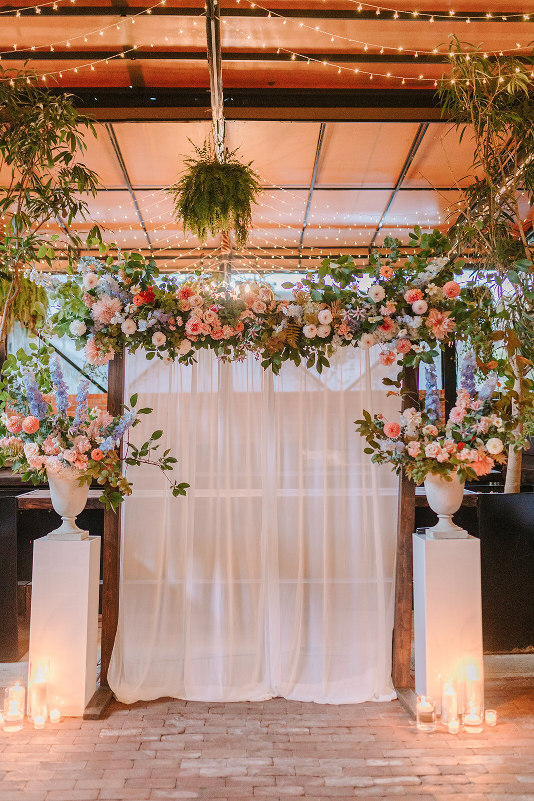 Large suspended garden flower arrangements for a wedding ceremony at Restaurant Richmond.  