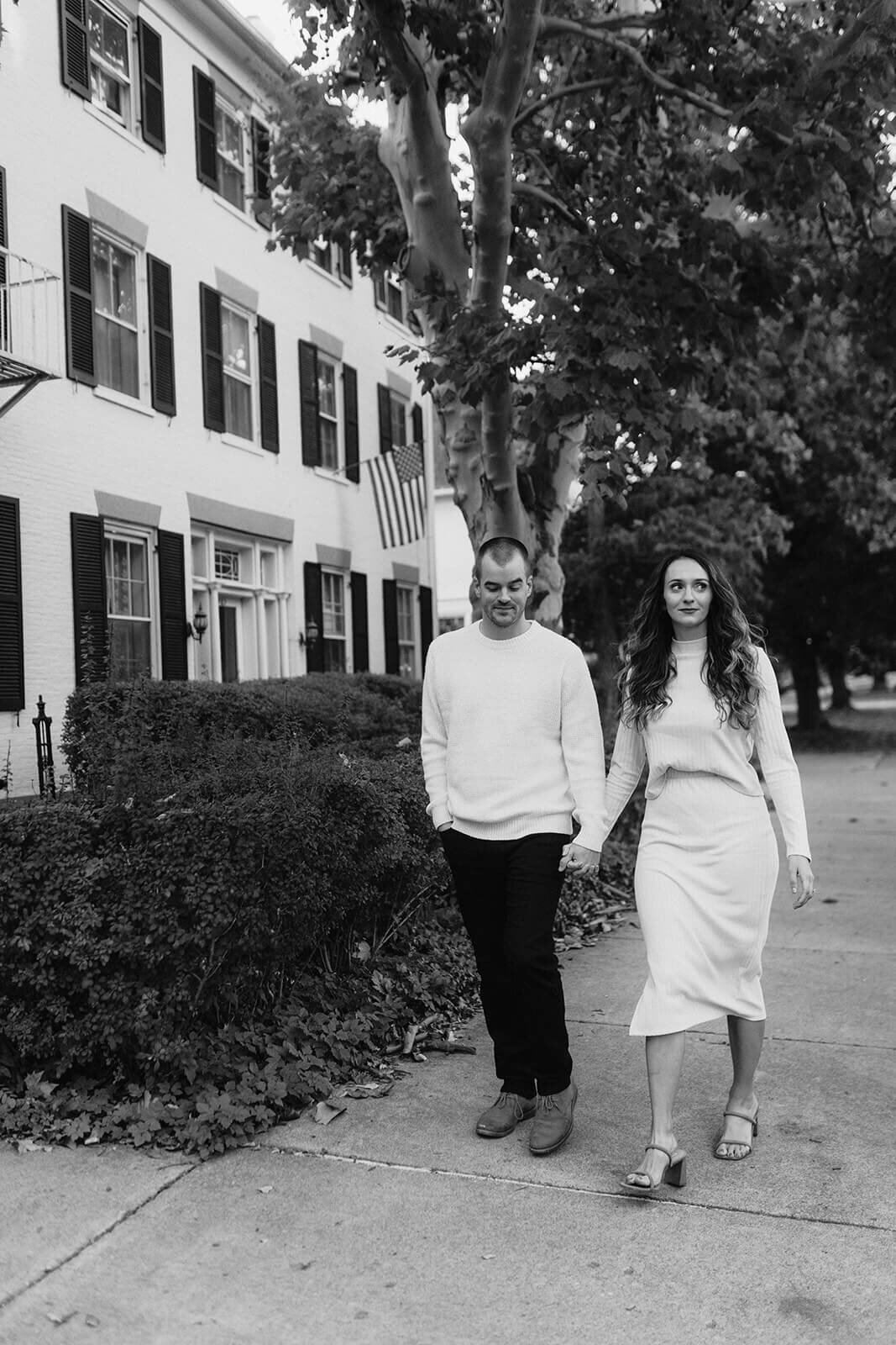 Couple walking along holding hands at Finger Lakes engagement session
