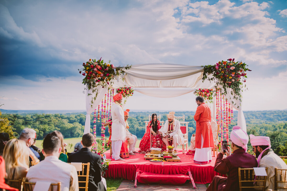 A cloudy hindu wedding ceremony outdoors overlooking new jersey at the natirar mansion