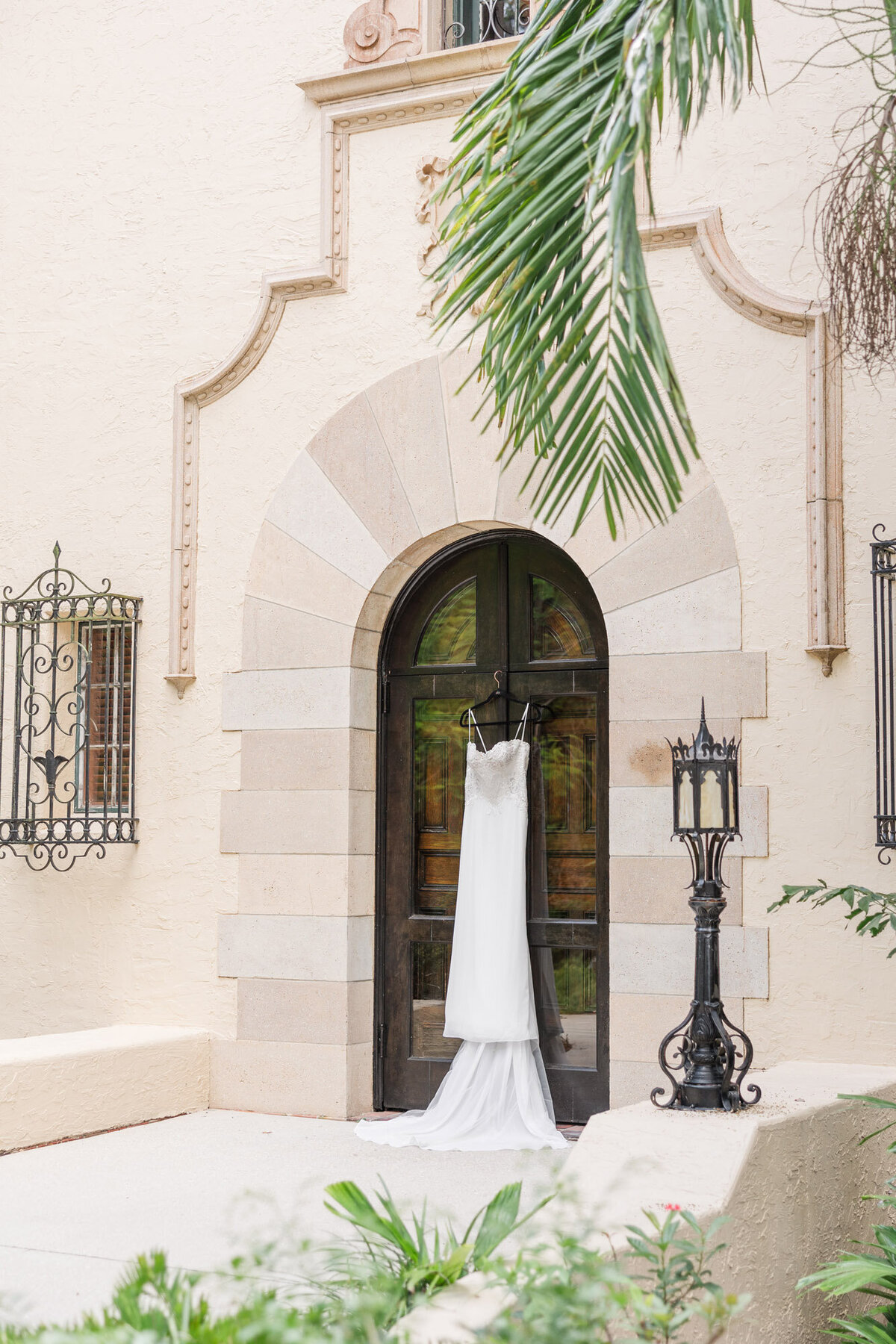 wedding dress hanging on a door