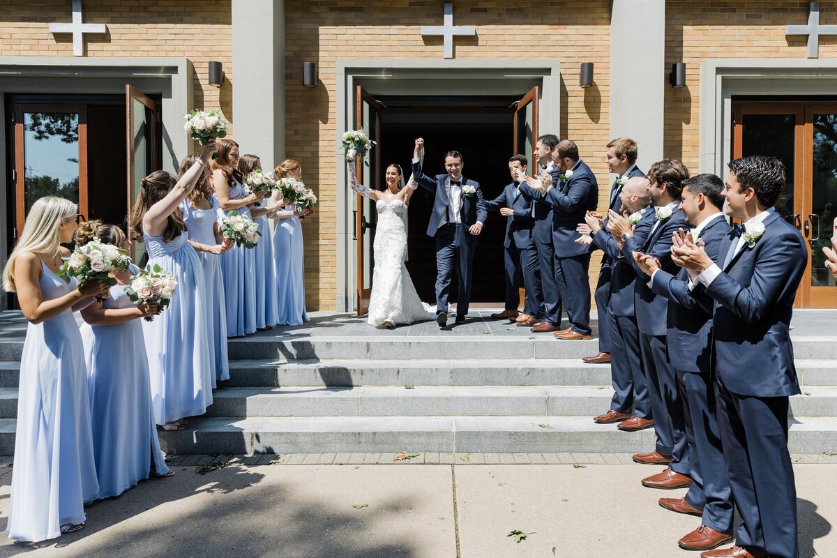 Bride and groom walking down the steps at Long Island wedding