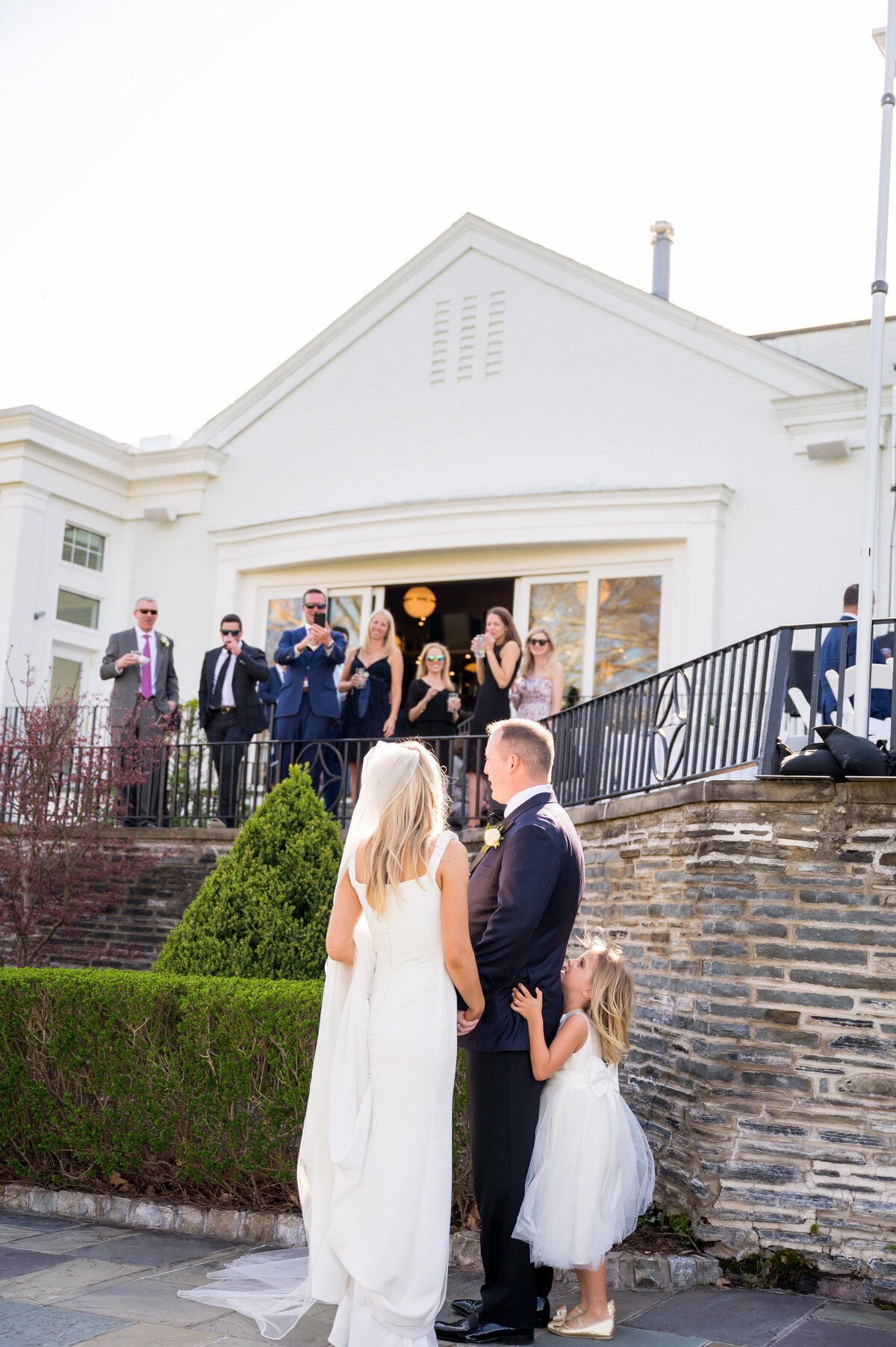 wedding couple looking at their guests on the veranda at the pittsburgh field club