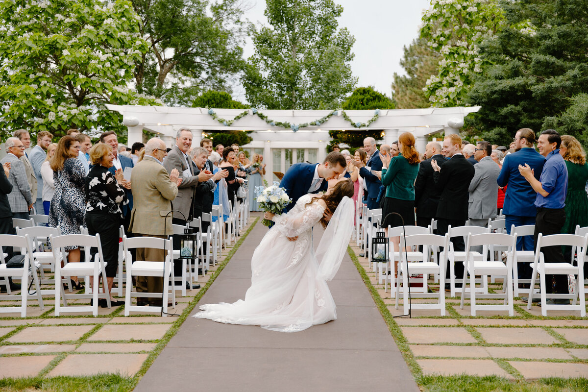 A bride and groom kiss after their wedding ceremony at Lionsgate Event Center in Lafayette, Colorado.