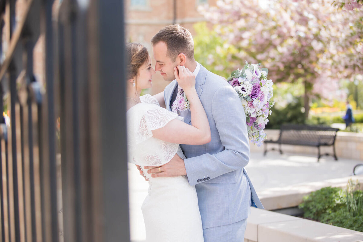 Man holding woman's waist while she touches his face