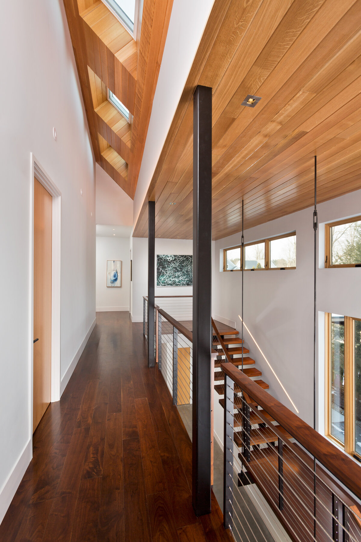 Upstairs hallways with white walls and windows