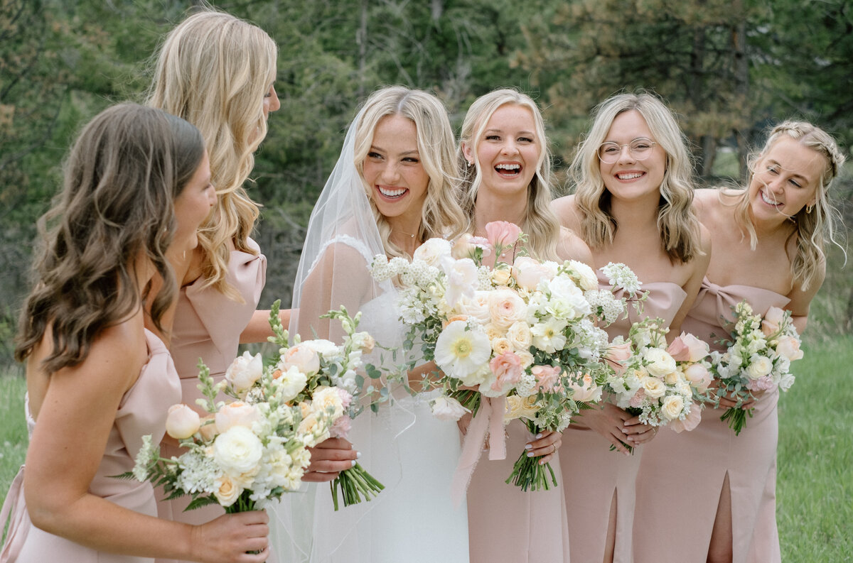 bride laughing with her bridesmaids