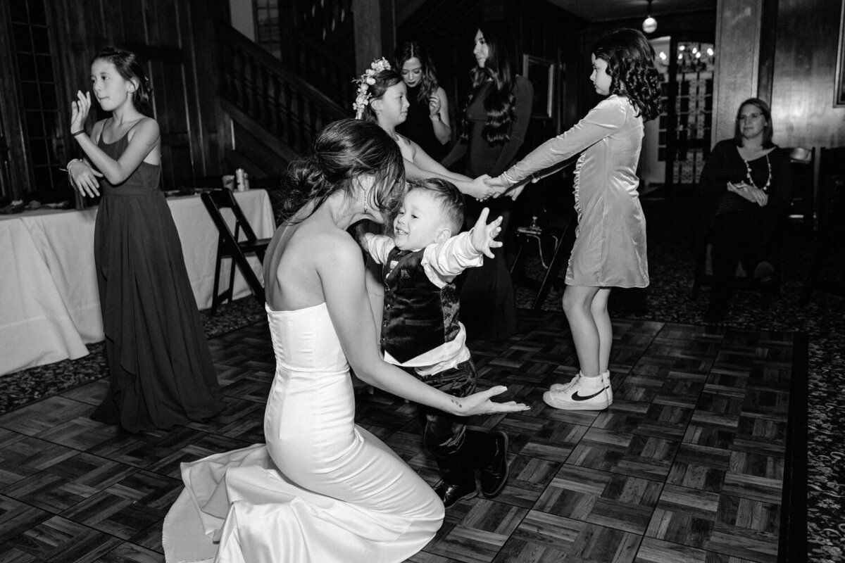 The bride's son leaps into her open arms on the dance floor