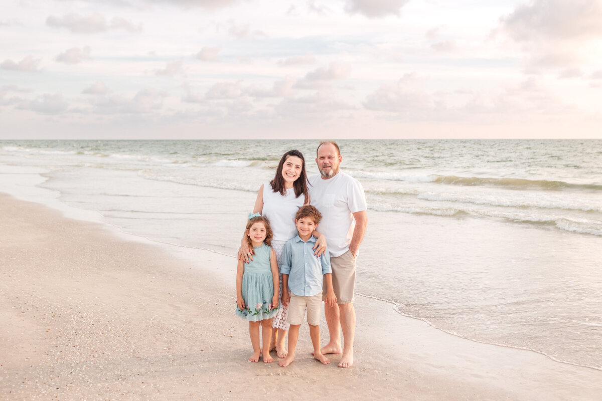 Family enjoying playful moments together on the shoreline at Indian Rocks Beach.