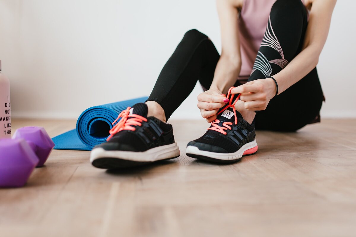 Woman tying her workout shoes