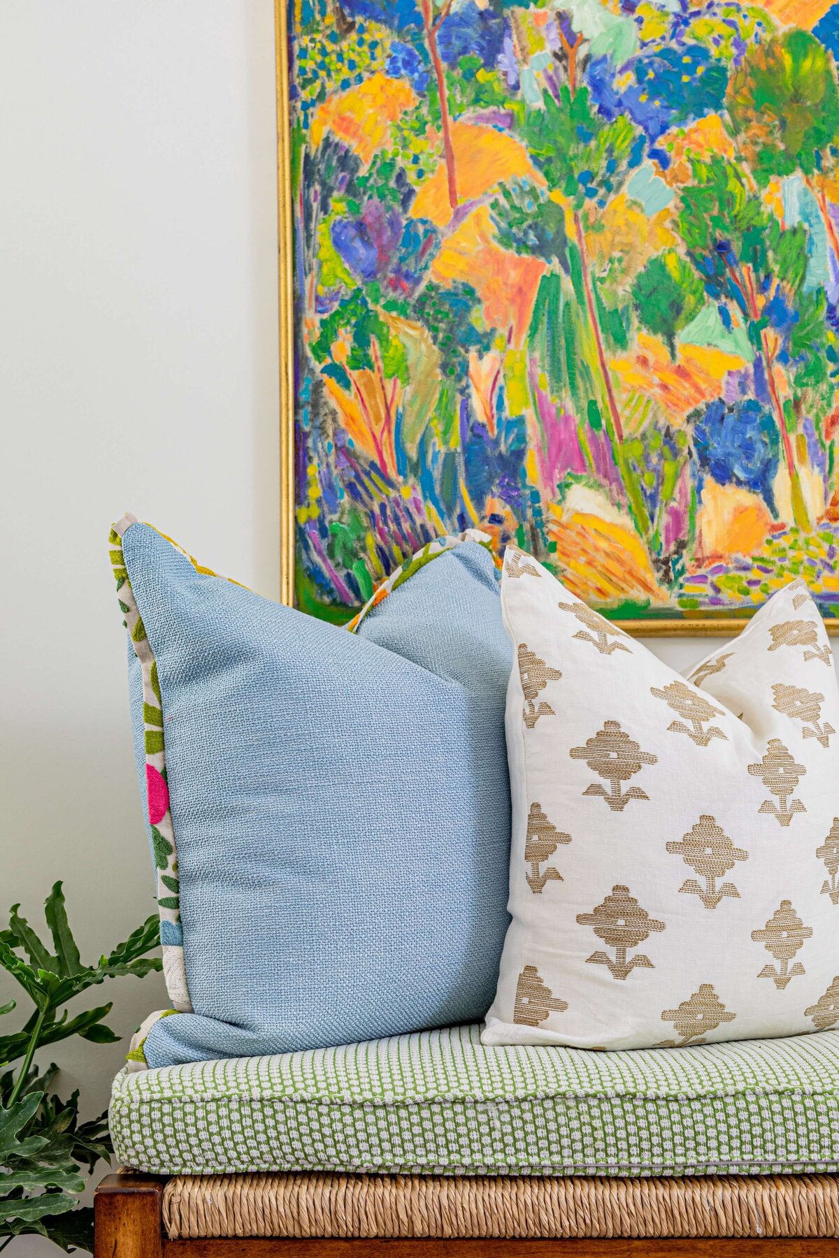 oyster creek studios highland park home detail of colorful painting with blue and white pillows on stool