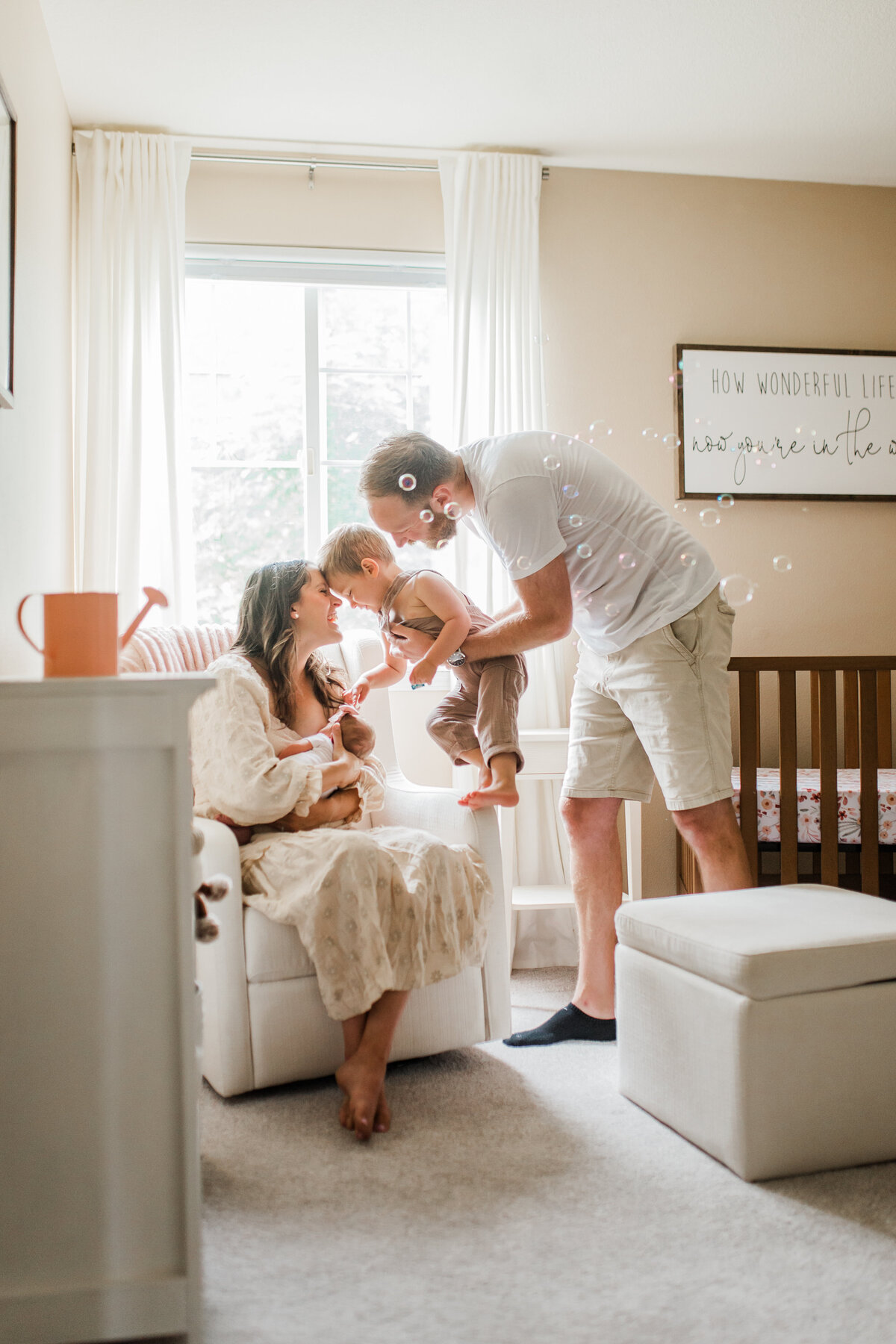 Family with a baby sitting in a nursery