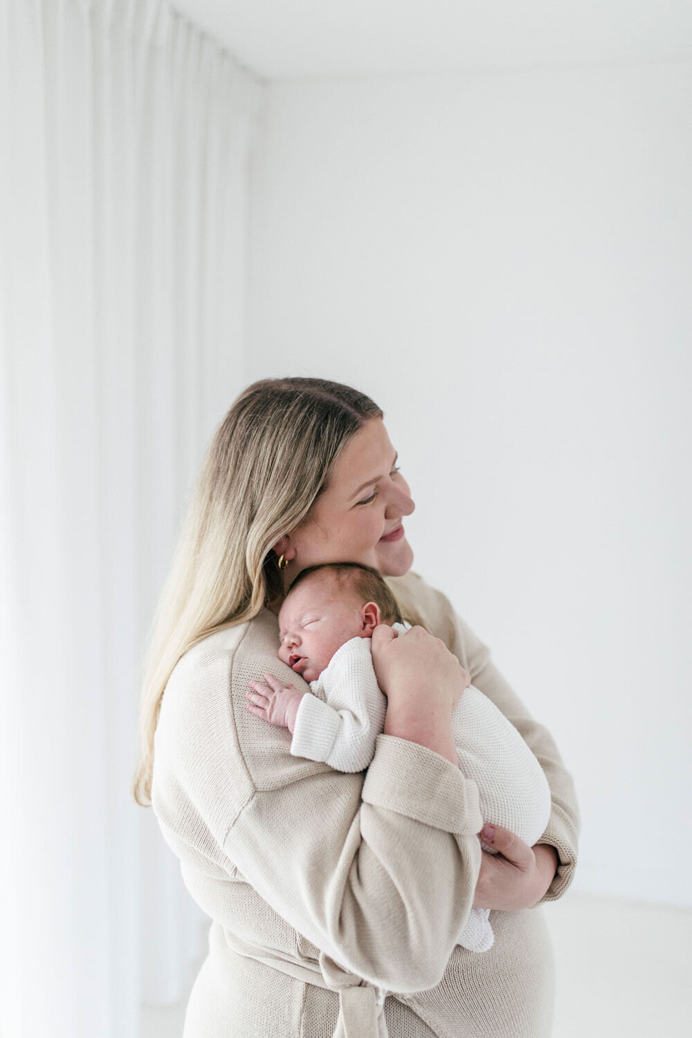 Mum cuddles newborn baby