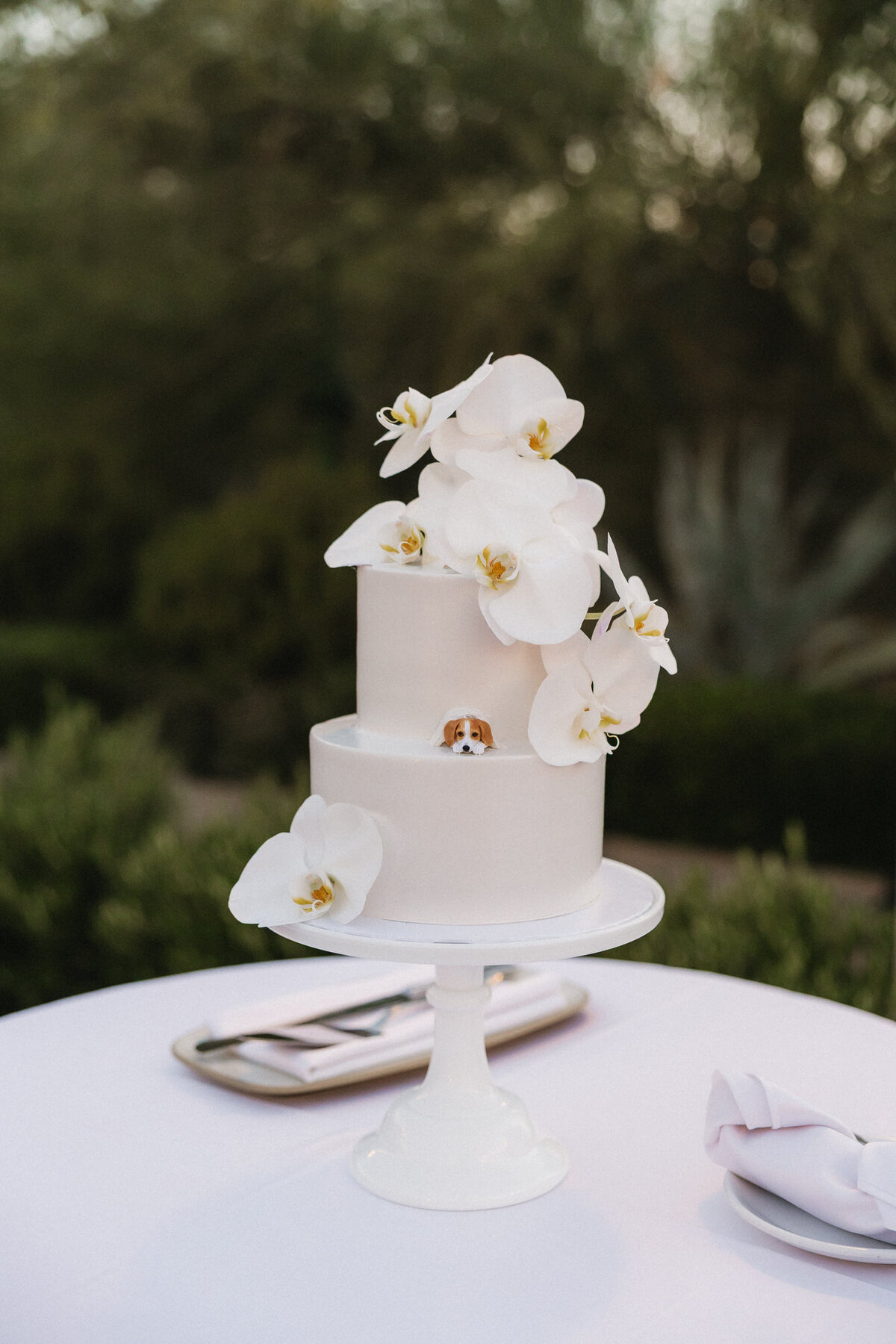 Wedding cake with flowers and dog figurine