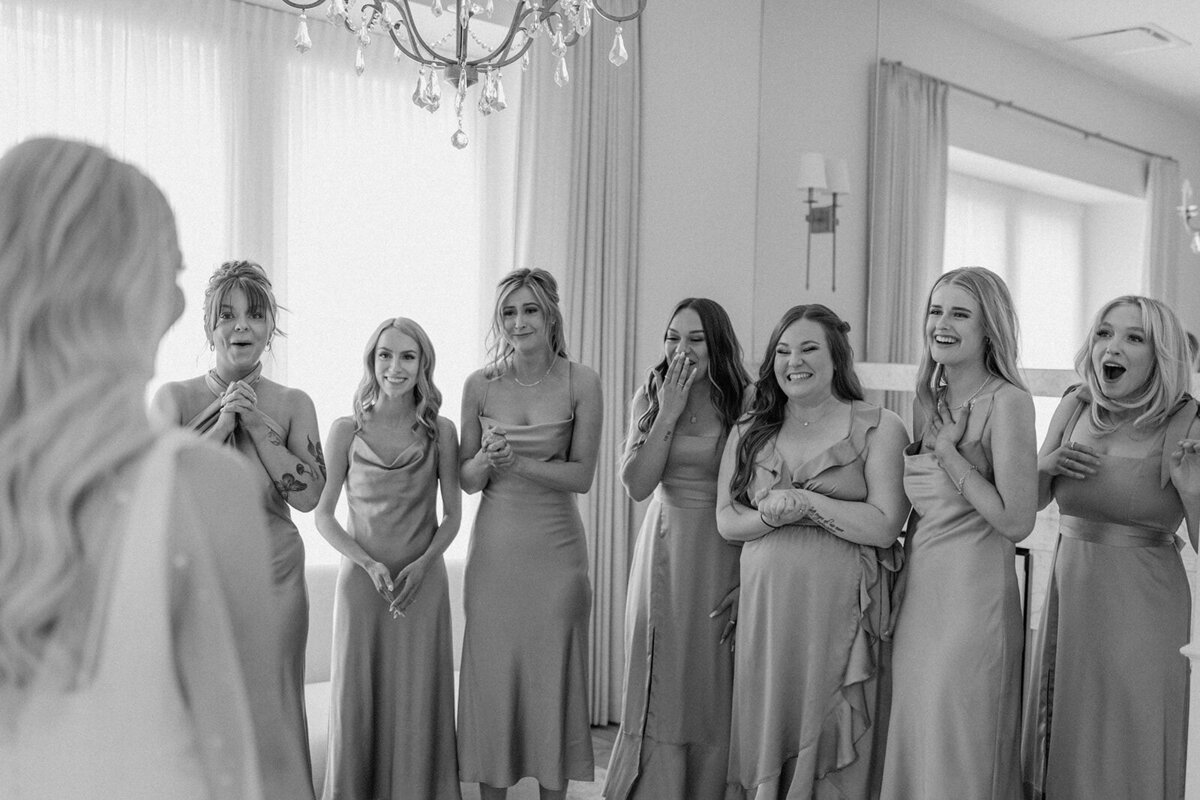 Bridesmaids seeing bride for the first time, , captured by Nikki Collette, featured on the Brontë Bride Wedding Vendor Guide.