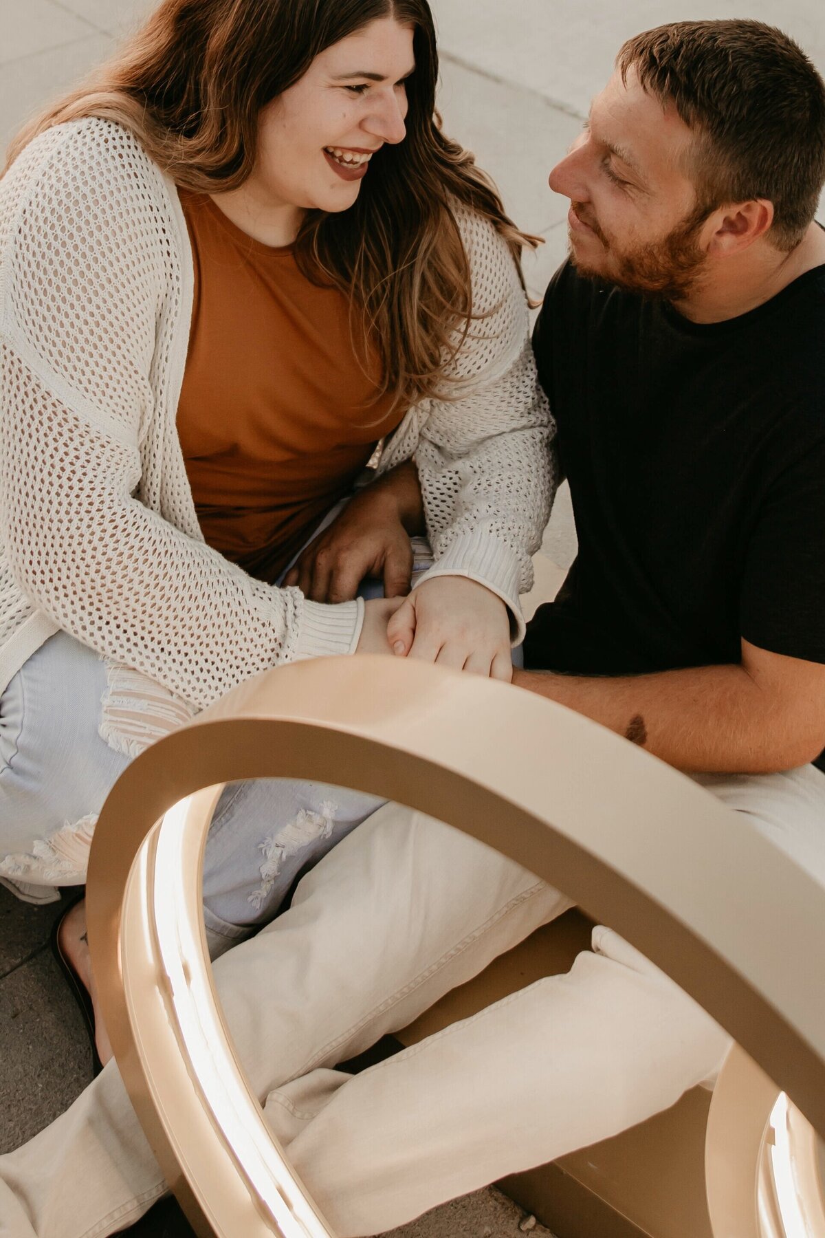 Couple-Laughing-Engagement-Downtown-Des-Moines-Waterworks-Park-Storyteller-Collective-Photo-Co