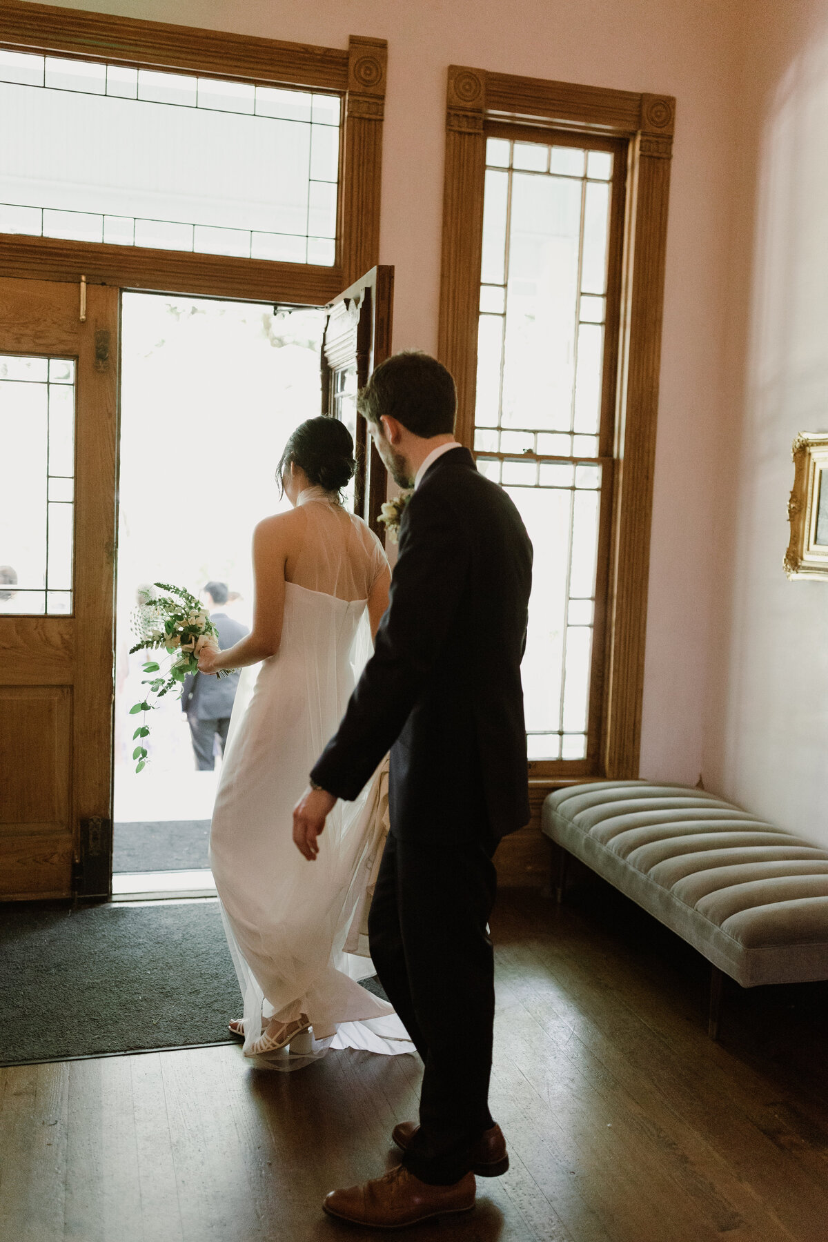 Bride and groom leaving through a door at Mattie's  Austin Wedding