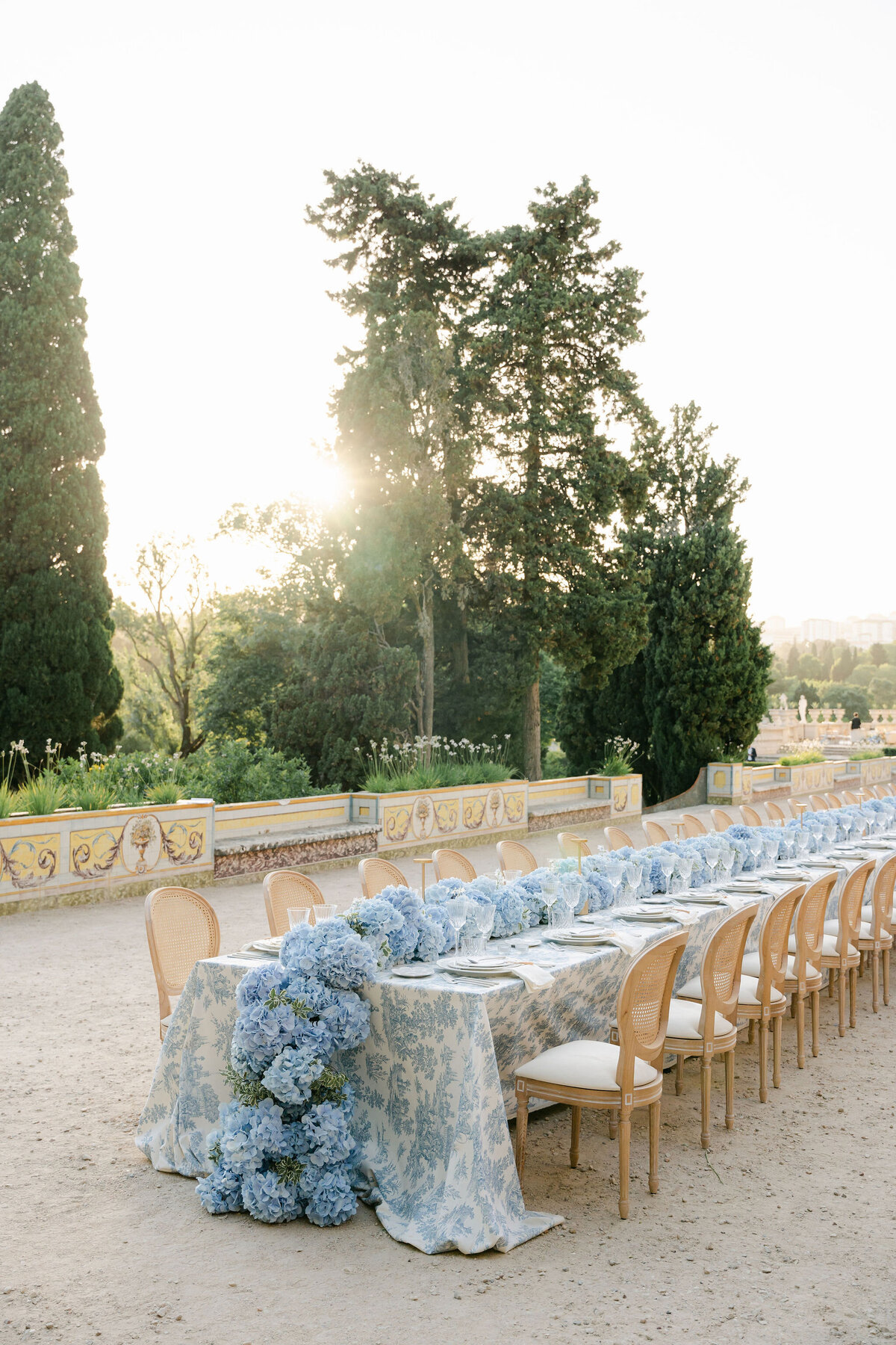 Toile de jouy wedding reception royal tablescape with a blue hydrangea runner