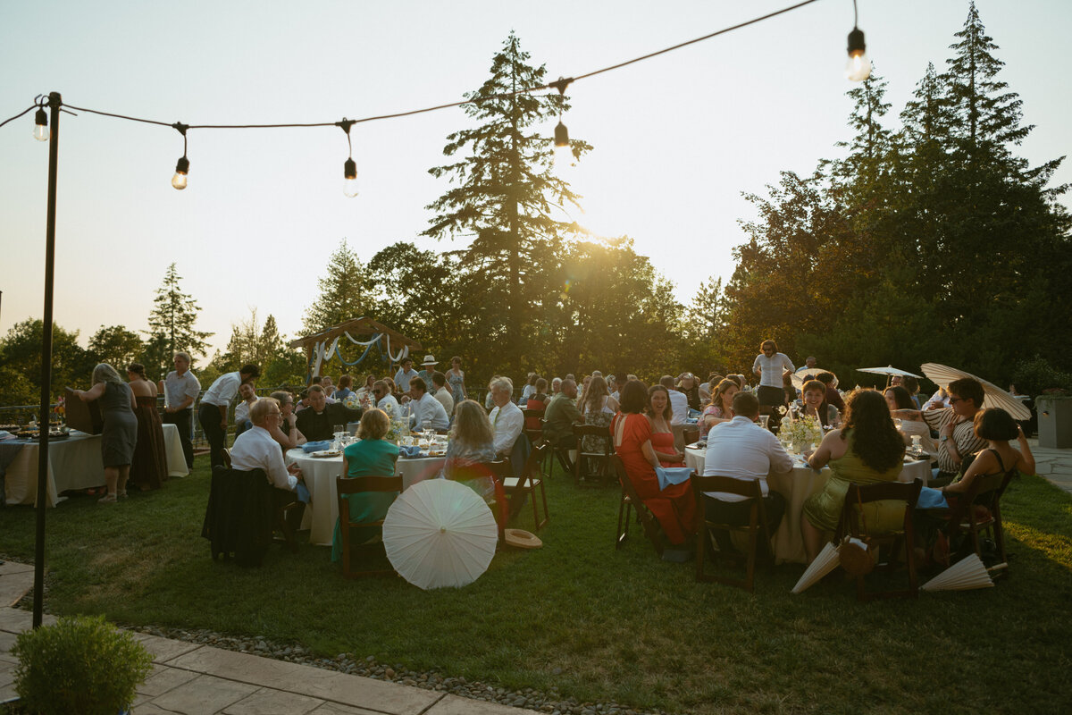PNW wedding Photography wedding guests sitting for dinner at sunset