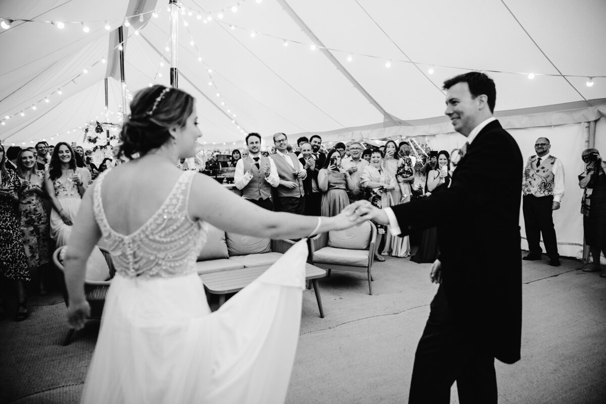 Black and White photo of bride and groom’s first dance at tented reception