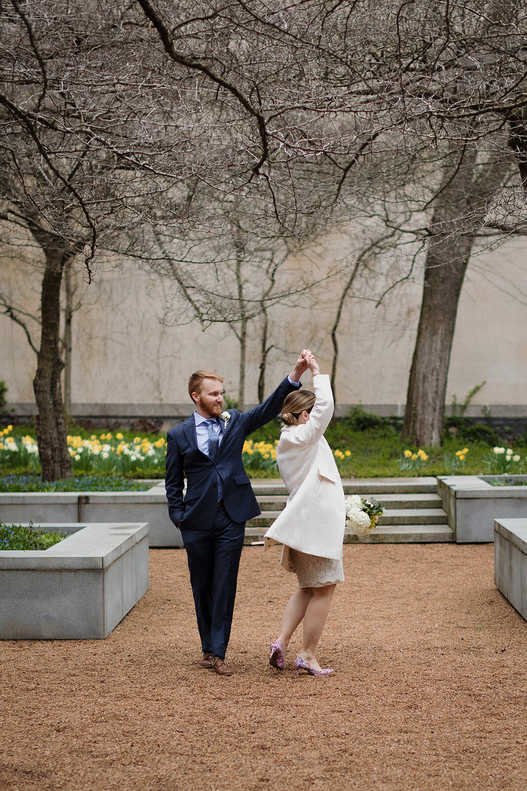 Just Married photo session  groom spins bride in the Art Institute Garden Chicago