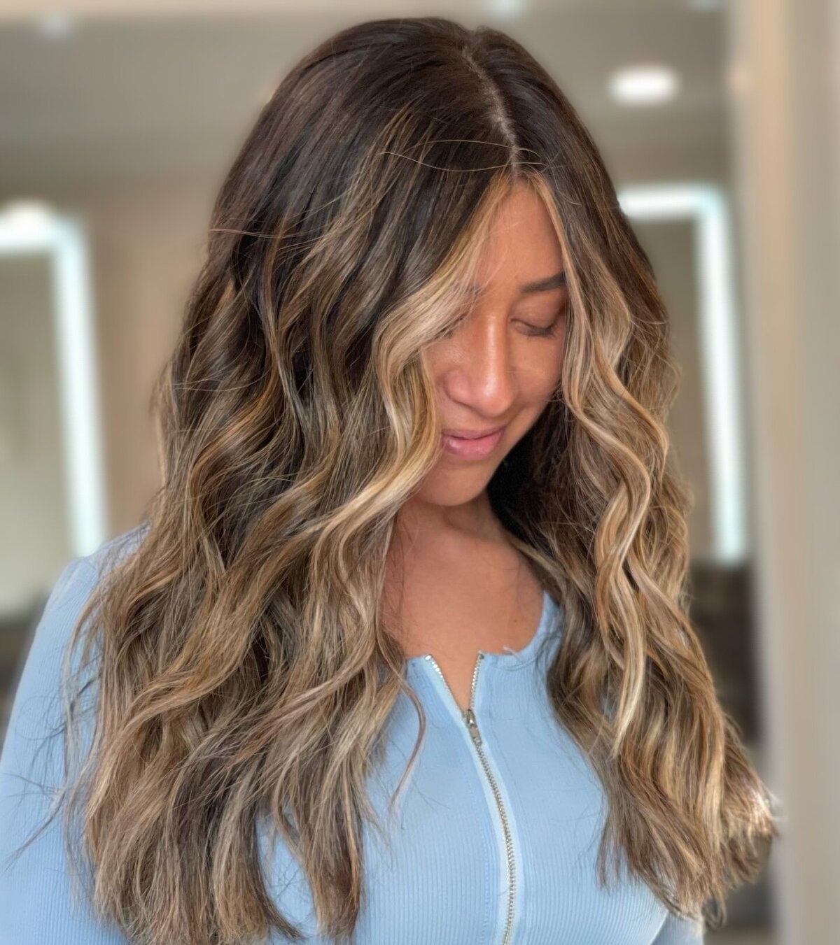 bold face framing highlights on dark brunette hair
