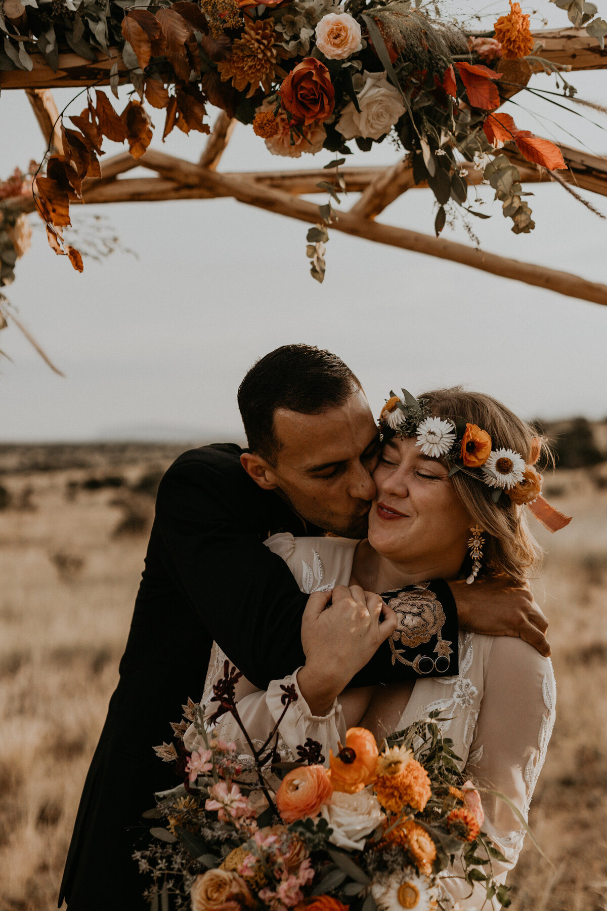 groom hugging and kissing bride from behind