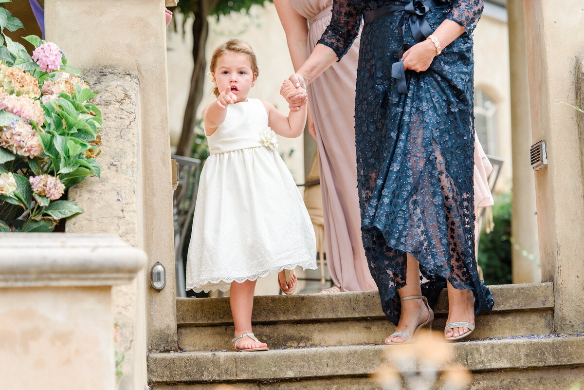 bride mom holding hand of flower girl