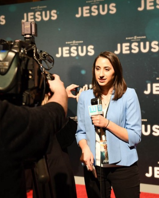 woman covering news at a corporate event planned by an event planner