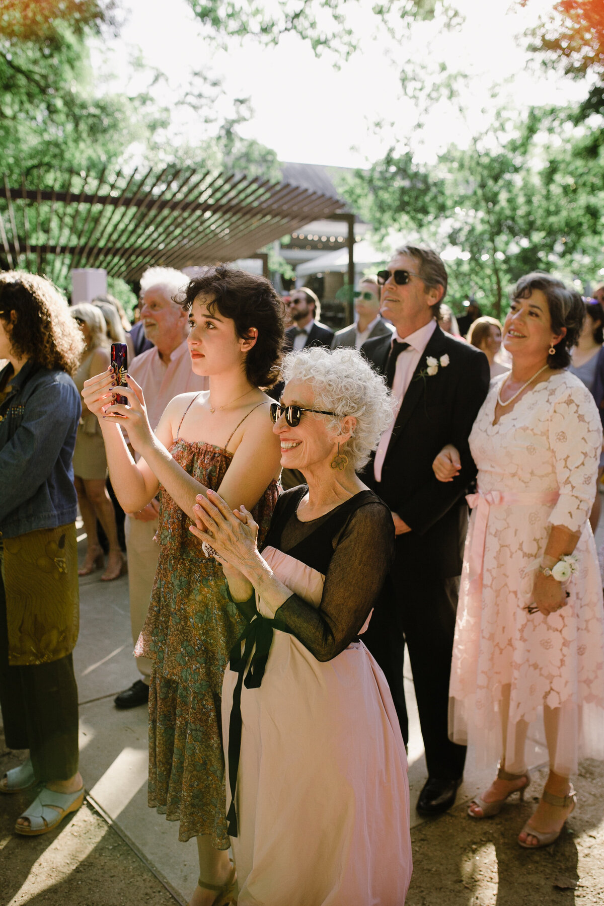 Guests at wedding ceremony at Umlauf Sculpture Garden, Austin