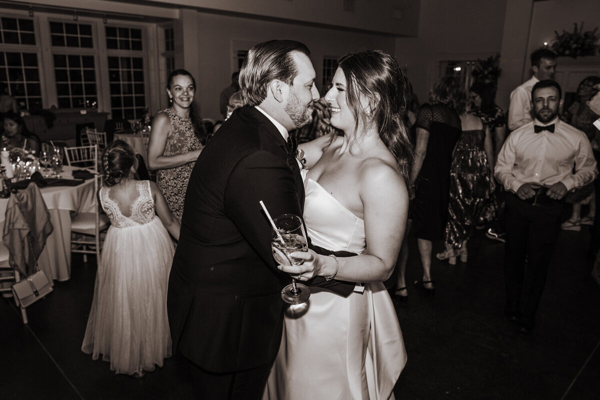 black and white image of wedding couple dancing and smiling