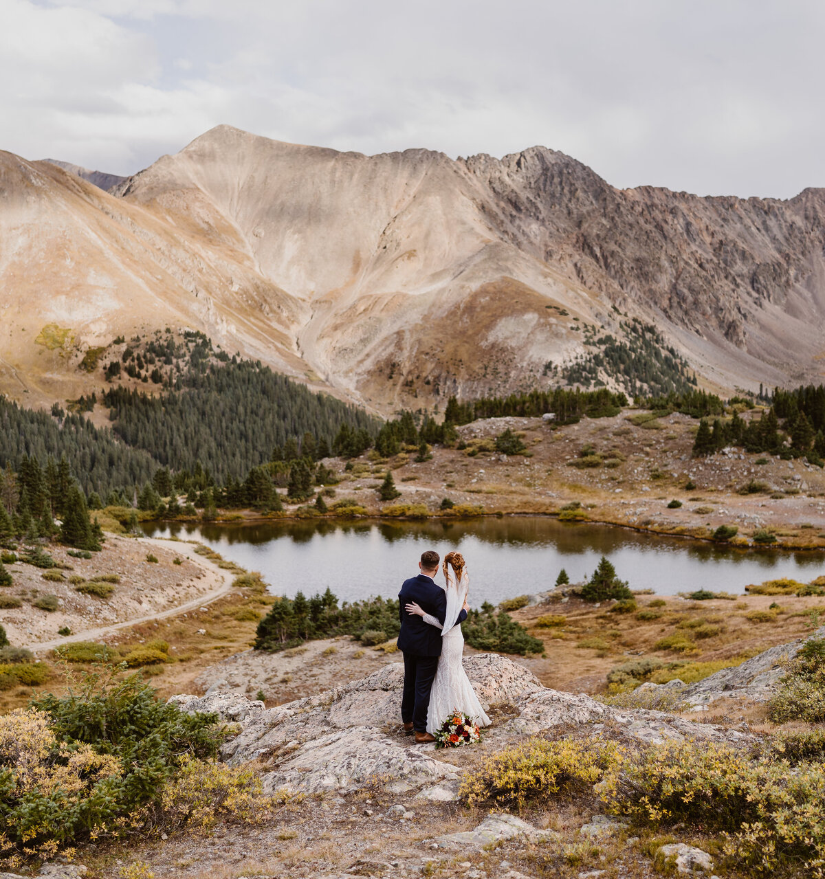 Couple stands at a lake near for their elopement near Breckenridge, Colorado