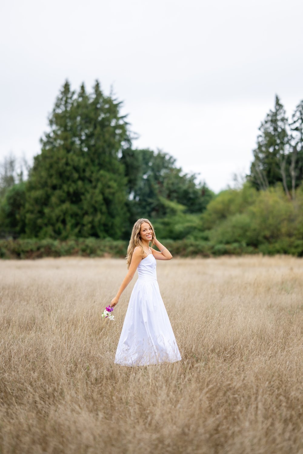 senior portrait session at discovery park in seattle in open field