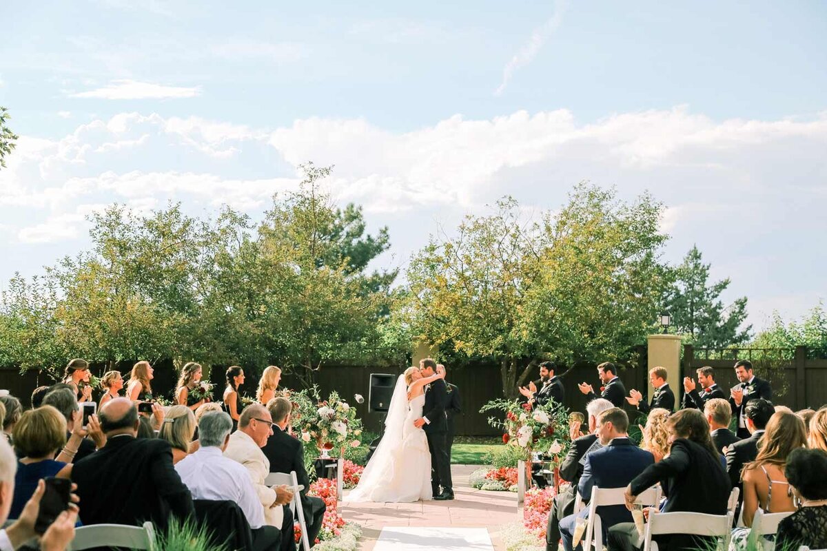 Bride and groom during the outdoor wedding ceremony at Pinehurst Country Club in Denver, Colorado