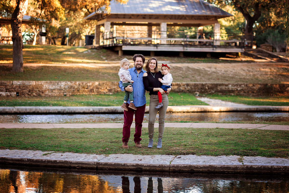 Adventure awaits in a family session with twins at Landa Park, New Braunfels. Enjoy laid-back moments, creating candid memories for young parents seeking a joyful photo experience.