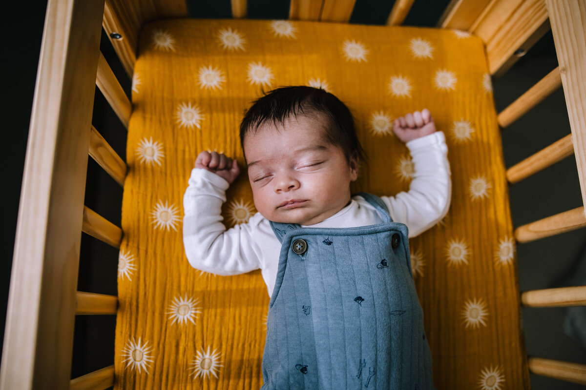 Newborn baby boy laying in his crib in Pittsburgh.