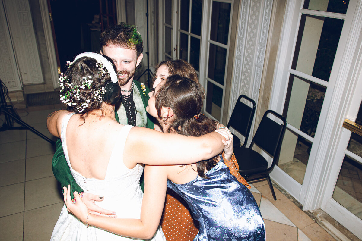 Friends dance with one of the brides during her reception at Armour House in Lake Forest.