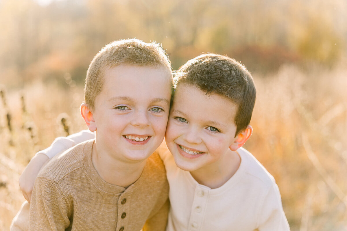 Two brothers smiling for their session with Jennifer Brandes Photography.