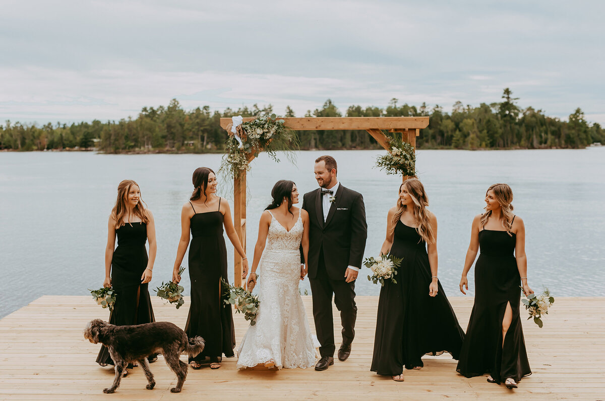 bride-smiling-at-groom-with-bridal-party