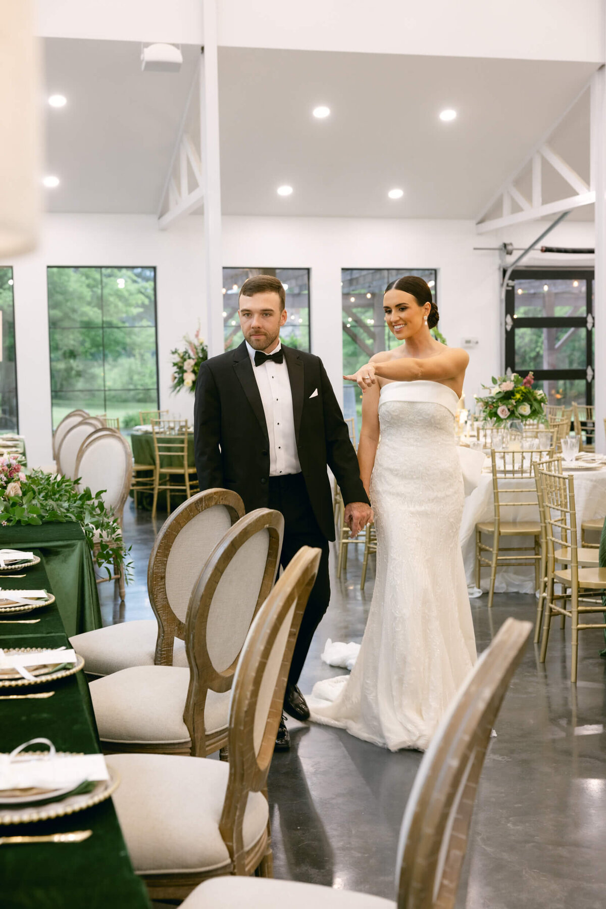 A wedding day photo of the bride and groom posing for a photo in the wedding reception area