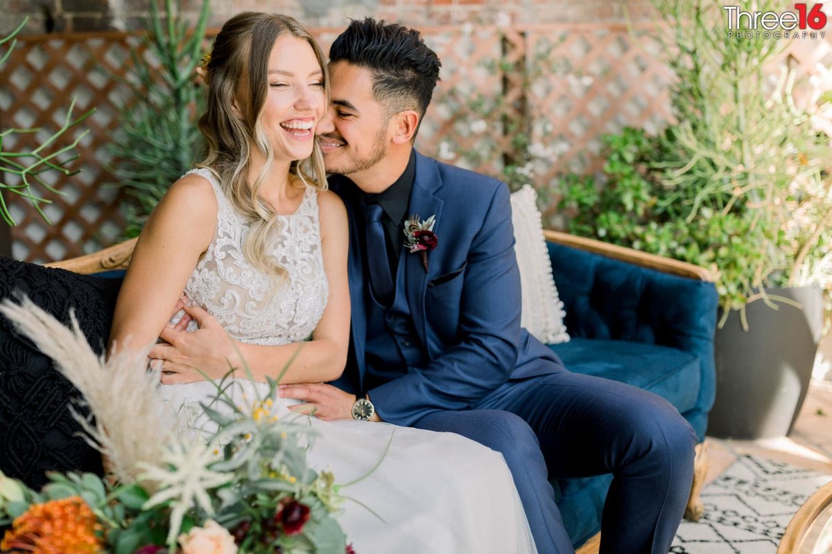Bride breaks out in laughter as Groom cuddles with her