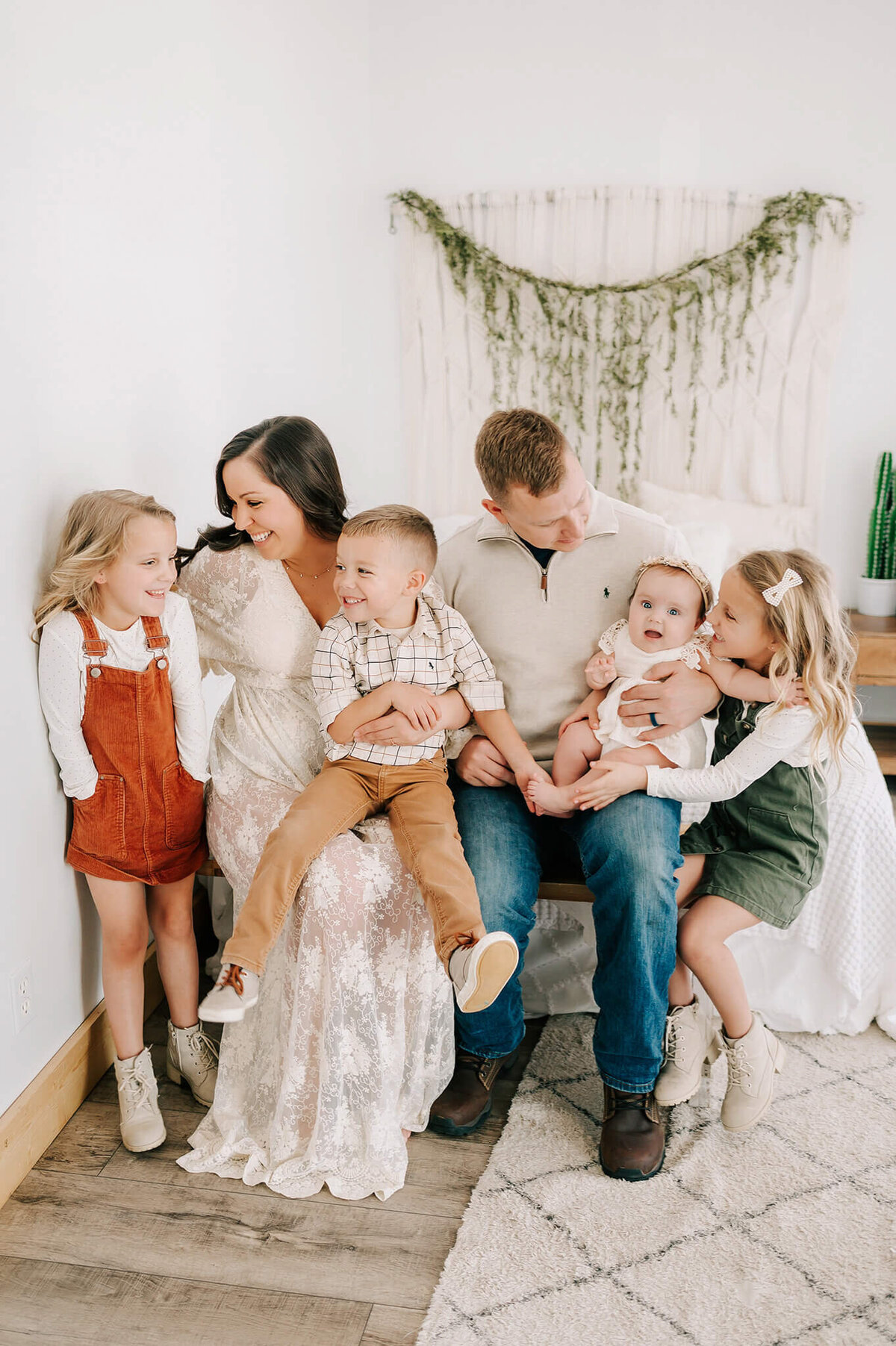 family laughing on bench together during Branson MO family photography session