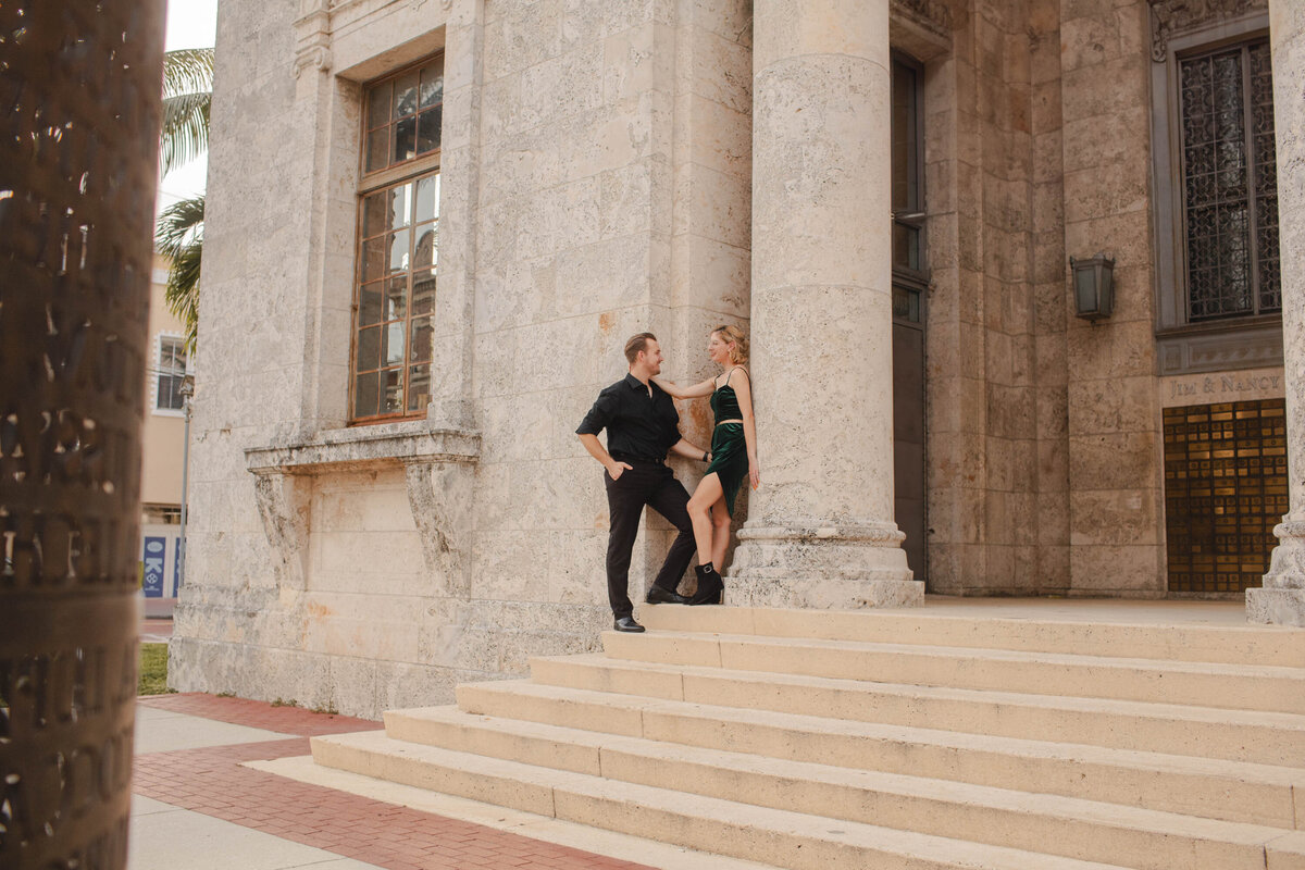 This image is of a couple posing for a portrait in downtown fort myers.