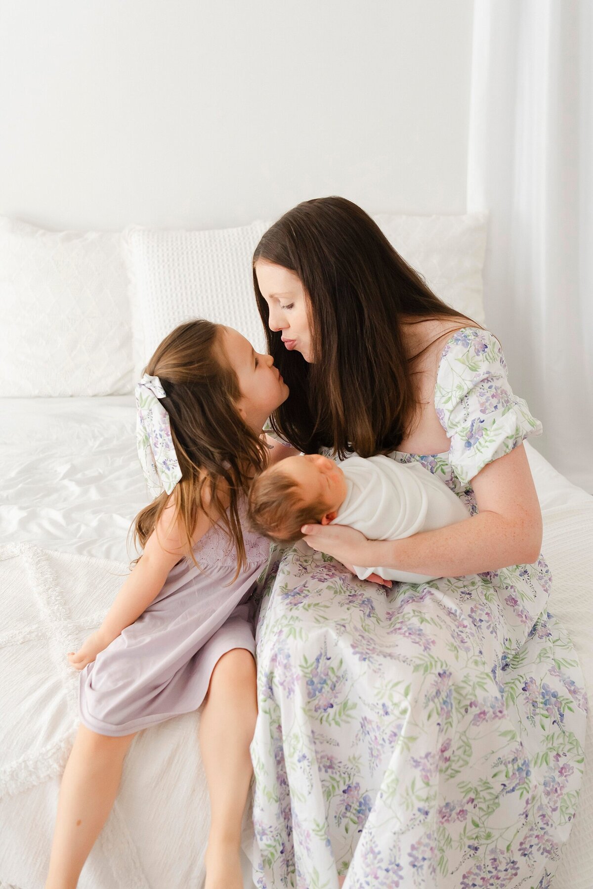 mom kissing daughter taken by family photographer boston ma​