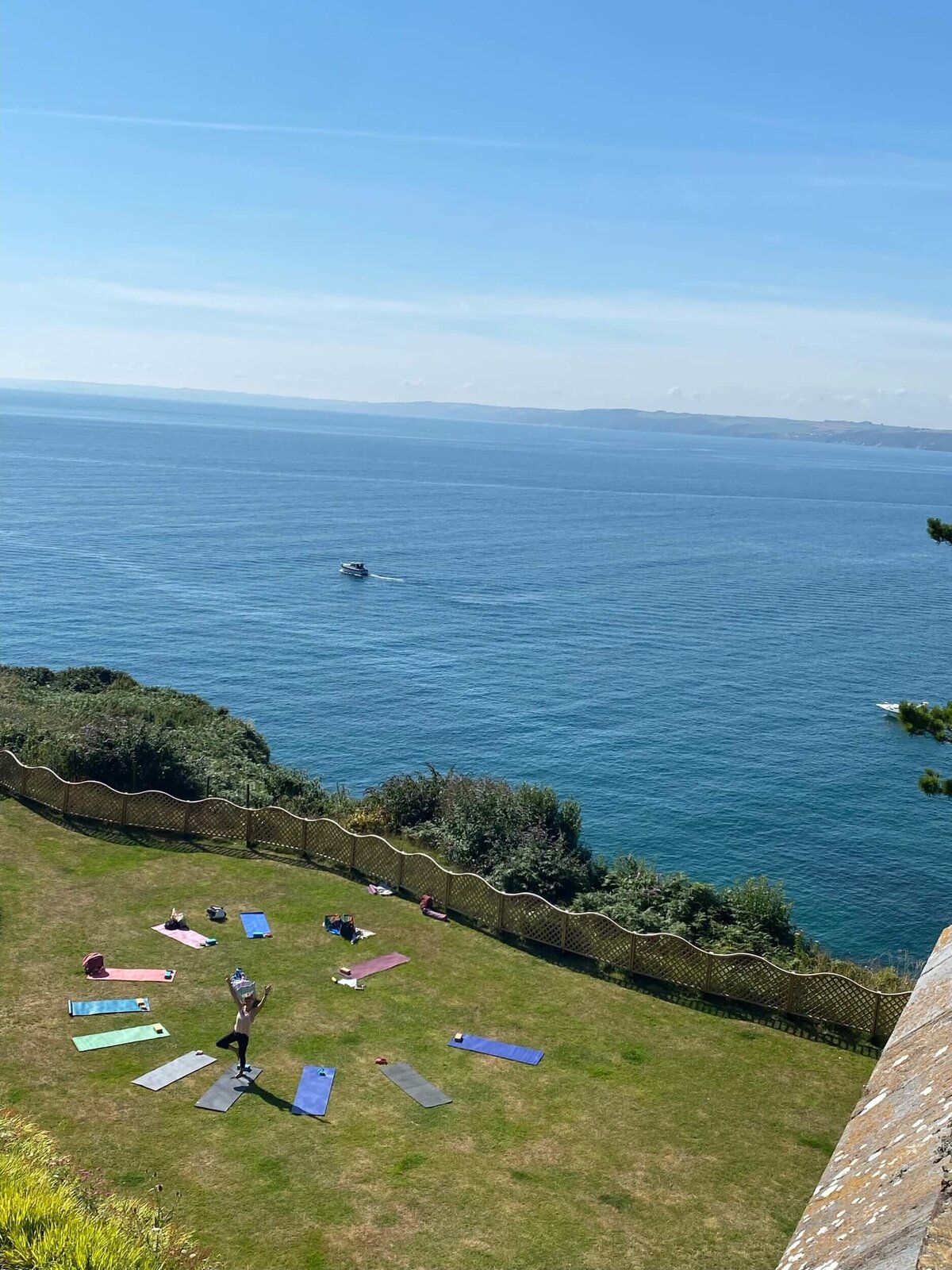 A view from above of the lawn with yoga mats laid out in a semi circle