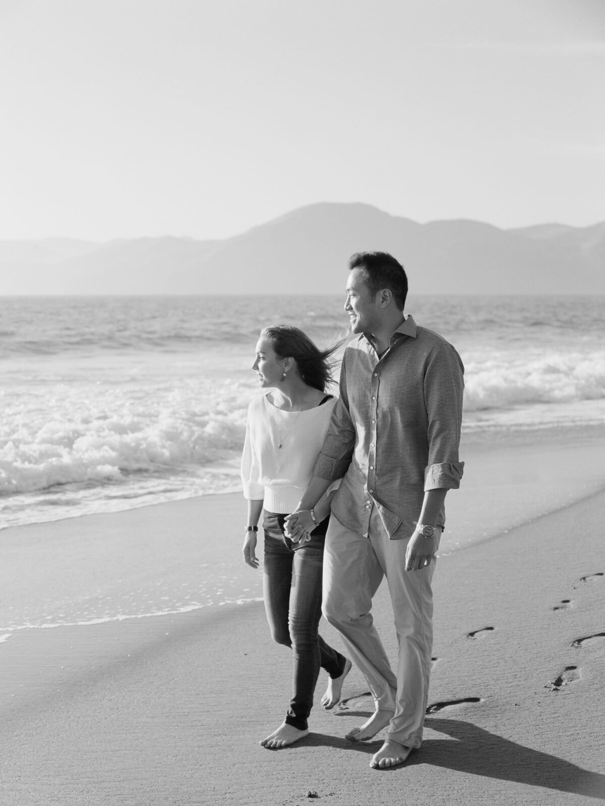 Asian man walks on the beach with his beloved partner.