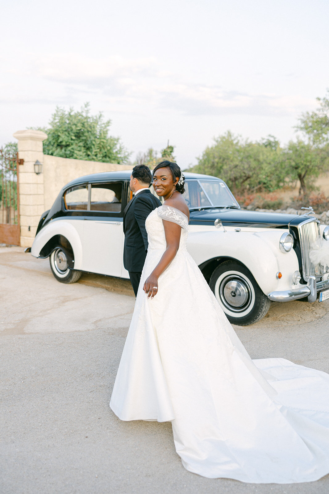 a groom leading his bride to their getaway car