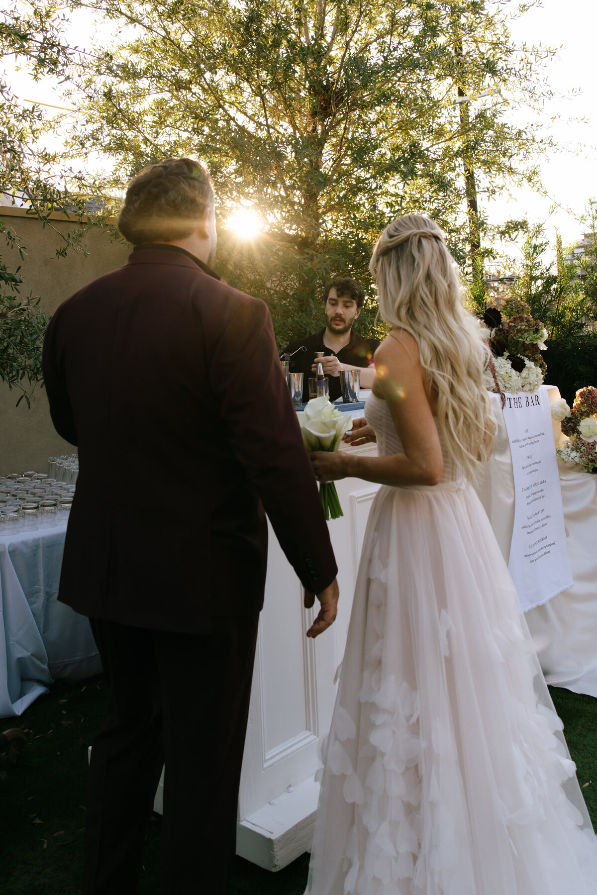 bride and groom at wedding bar during sunset