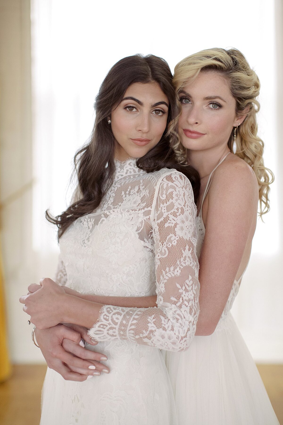 Two Brides embrace.